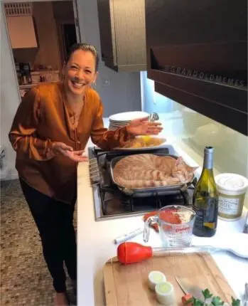 Kamilla Harris and her cat in the kitchen.